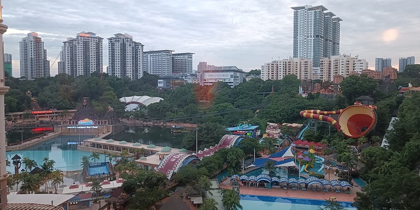 An image of a water park with pools, slides, colourful tents and buildings in the Sunway Lagoon theme park