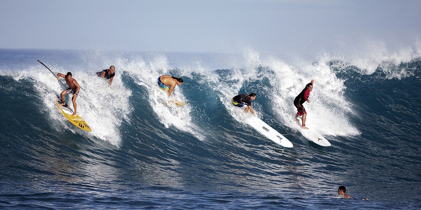 A group of surfers surfing at Main Point Beach, an exciting thing to do in Arugam Bay.
