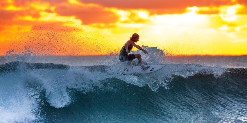 View of a surfer on the thrilling waves of Semniyak beach