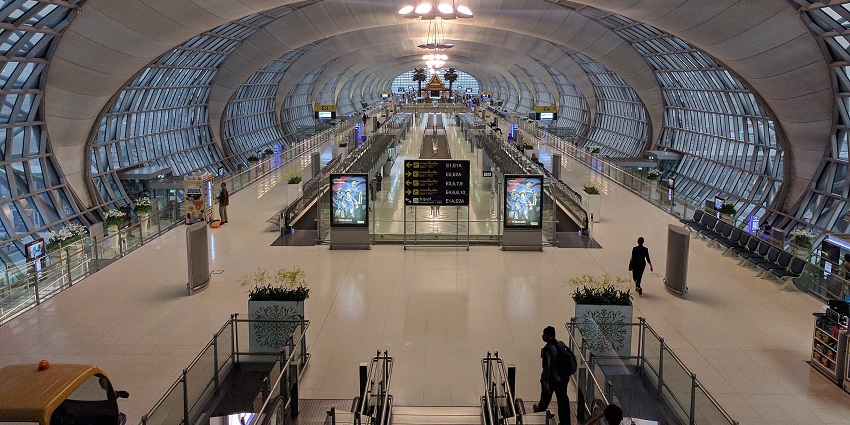 An image of Suvarnabhumi International Airport in Asia, featuring Terminal E's interior at dusk