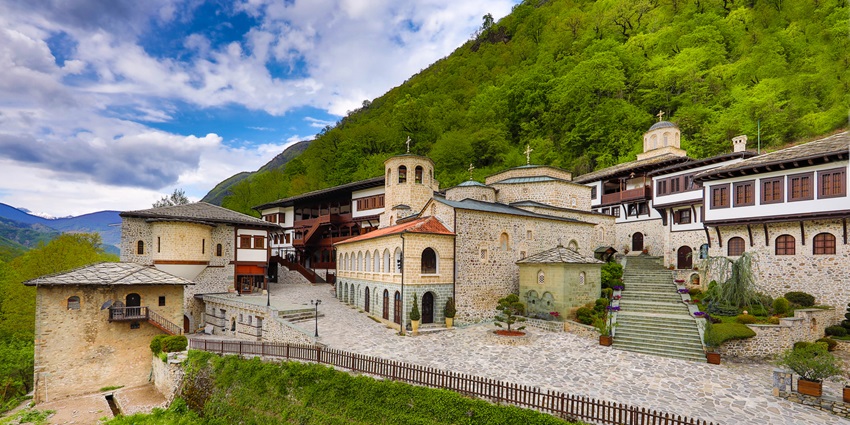 Panoramic view of Sveti Jovan Bigorski Monastery set in lush green mountains.