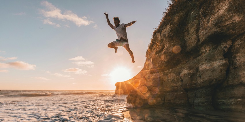 Image of a man cliff jumping, a thrilling activity for adventure lovers