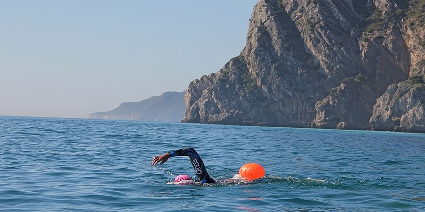 Image of a man swimming around the beach - Have fun swimming in the beach