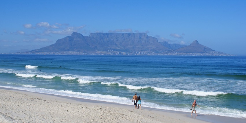 A breathtaking view of Table Mountain with a flat top, overlooking Cape Town and the ocean.