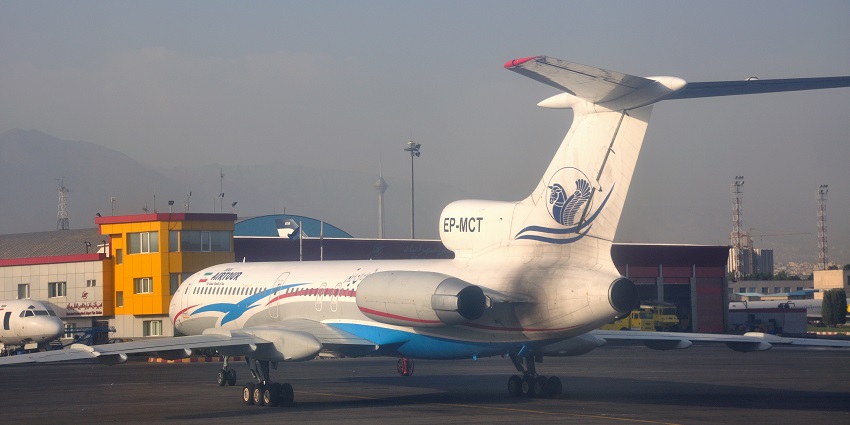 Airtour aeroplane standing near another aeroplane which is parked next to the terminal building.