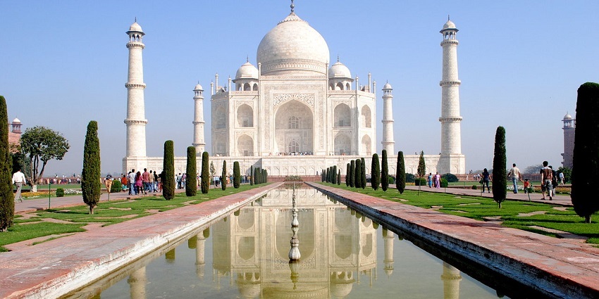 A magnificent view of the Taj Mahal, showcasing its pristine white marble structure against a clear blue sky.