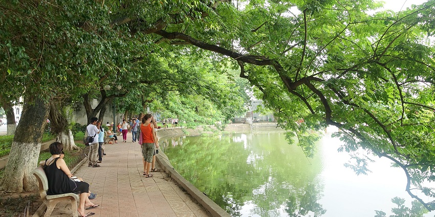 Visitors walking along the scenic pathways of Hoàn Kiếm Lake