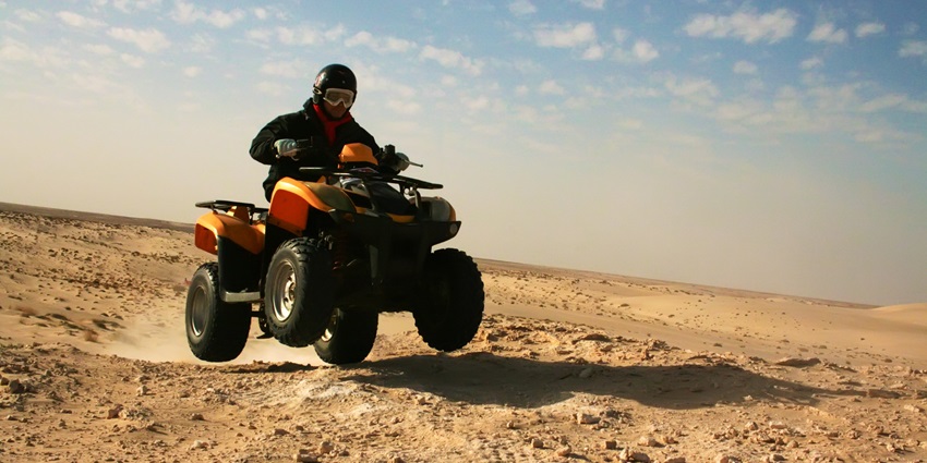 Feel the adrenaline rush as you navigate rugged dunes on a thrilling quad biking adventure.
