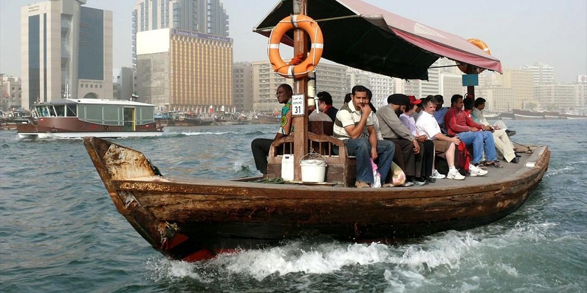 Passengers enjoy a scenic abra ride, one of the must-do things to do in Dubai Creek