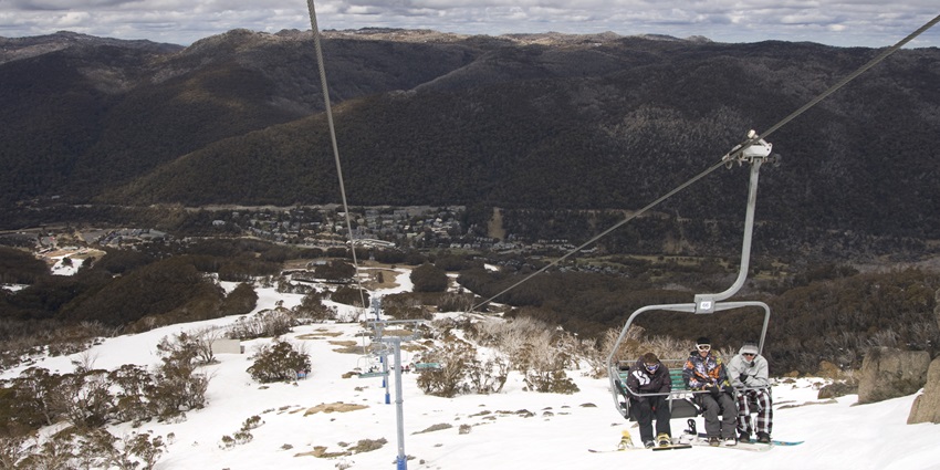 Panoramic views of tourists riding a scenic chairlift up Mount Kosciuszko.