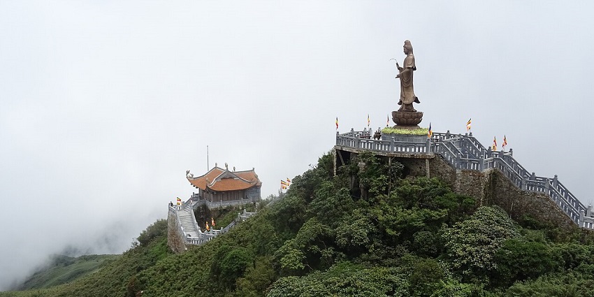 Panoramic scenery from the Fansipan cable car, featuring misty mountains and green valleys