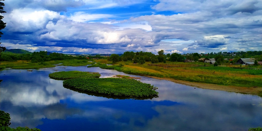 Takhat lake with still waters, surrounded by hills and a breathtaking natural environment.