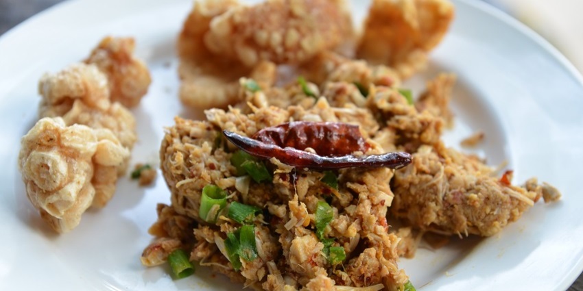 A spicy Northern Thai salad made with boiled green whole jackfruit which has been mashed with a mortar and pestle, and minced pork