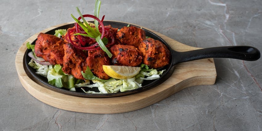 Smoky tandoori chicken, a marinated and char-grilled dish one of the best foods in India