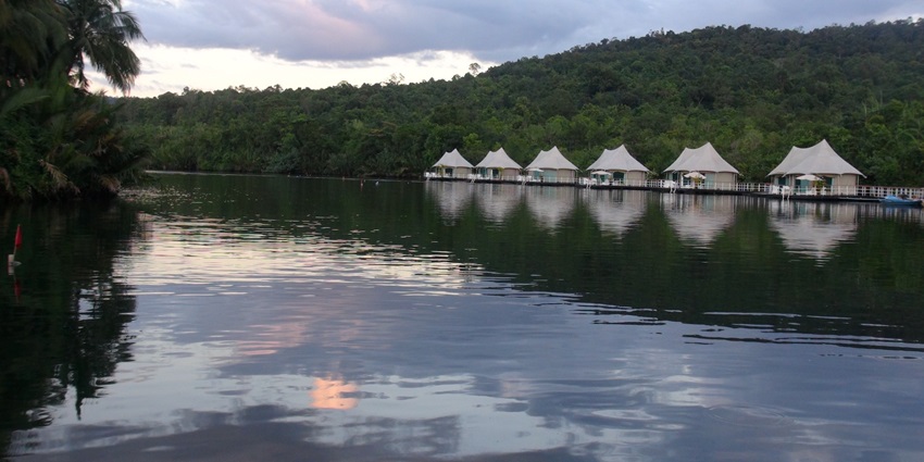 A stunning view of the Tatai River featuring shimmering blue water and lush greenery.