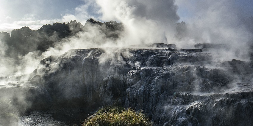 A view of Te Puia with the Pohutu Geyser erupting, one of the places to visit in Rotorua.