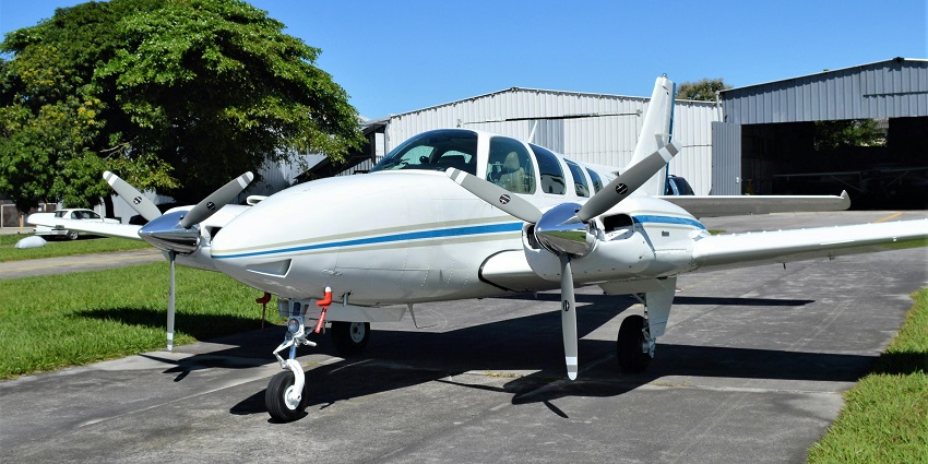 A small aircraft is sitting on the runaway at one of the major airports in Honduras.