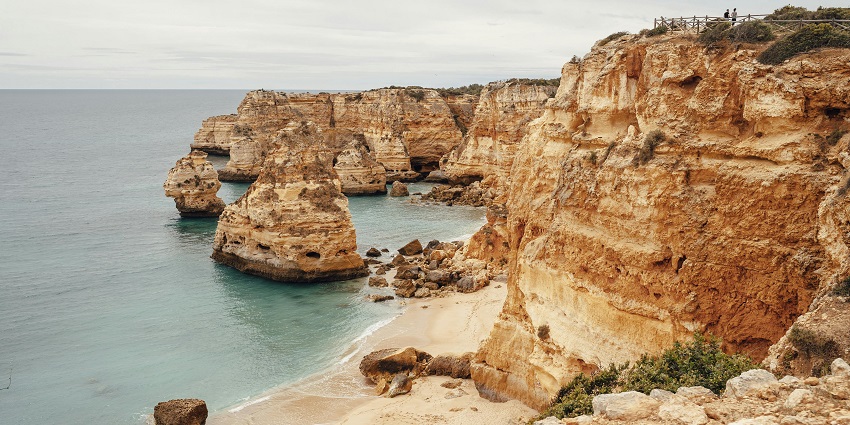 Places to visit in March in Europe include The Algarve’s golden beaches, dramatic cliffs.