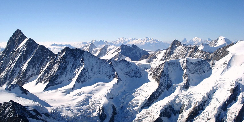 An image showing a trekking route in the Alps with mountain trails and rugged terrain.
