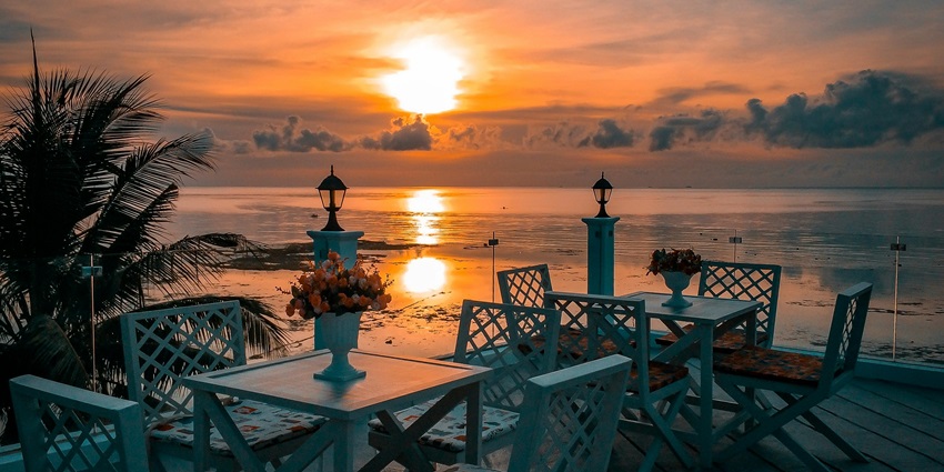 Image of White Wooden Tables With Chairs Near Sea during Sunset - similar to The Cloud Restaurant, Malé