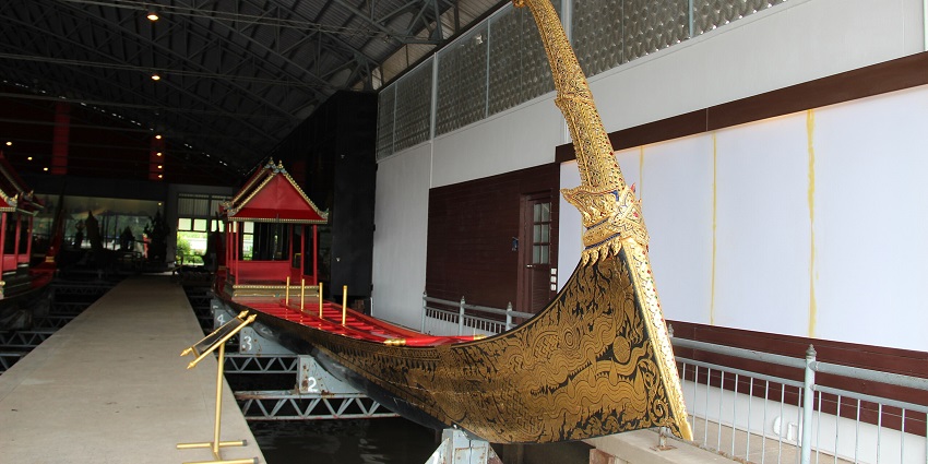 Traditional Thai royal barge adorned with detailed carvings and gold embellishments.