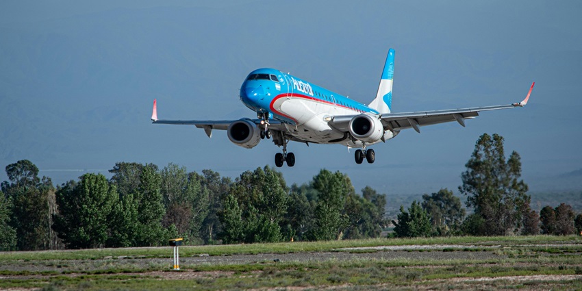 A truck moving about the runway carrying the essentials of the aircraft waiting for takeoff.