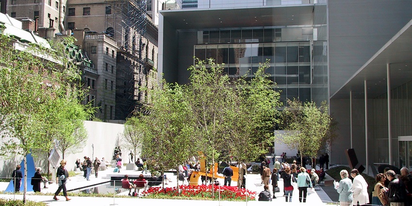An artwork displaying ‘Moma Highlights’ placed at a glass door in the Moma Art Museum.