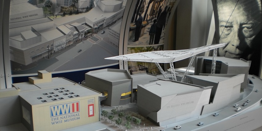 An image of a detailed architectural model showcasing The National WWII Museum's layout, labelled buildings, and canopy.