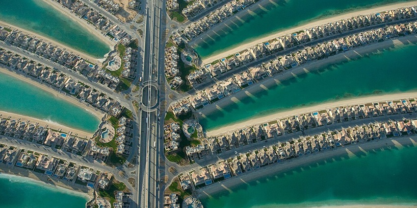 Dubai's Palm Jumeirah, showing roads and turquoise waterways on palm-shaped fronds.