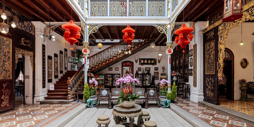Aesthetic interiors of Pinang Peranakan Mansion with Chinese lanterns and flower pots