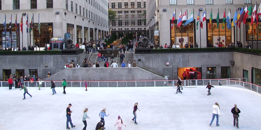 An image of the Rockefeller Center Ice Rink, glowing under twinkling holiday lights.