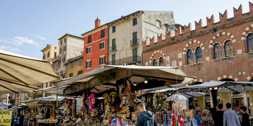 Rocks Market, with brick-paved street, white-canopied stalls, tall buildings, and lively visitors.