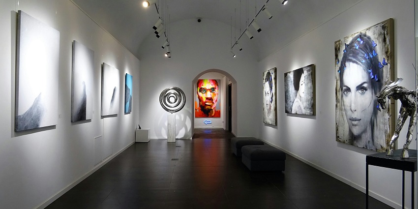 An image of a contemporary art gallery interior featuring abstract paintings, similar to the Sean Schuster Fine Art Gallery.