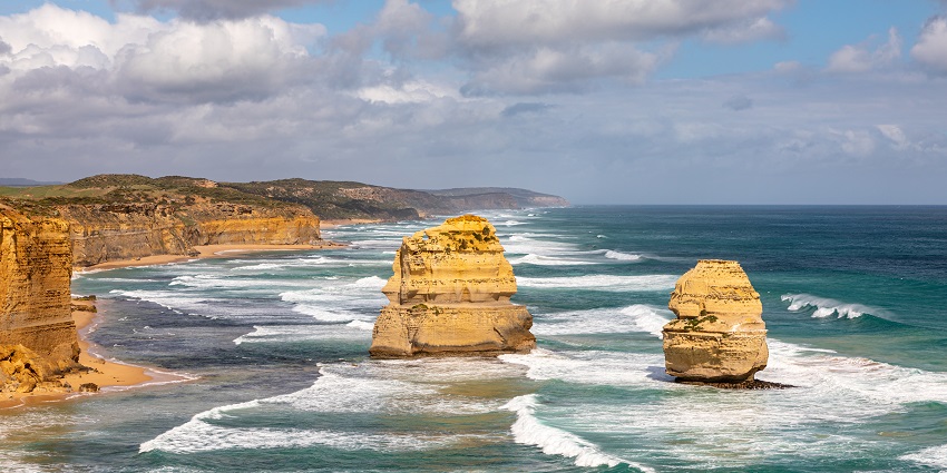 A stunning sunset view of the Twelve Apostles rock formations along the Great Ocean Road.
