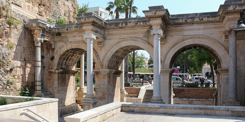A close-up view of the ornate carvings on Hadrian's Gate's stone arches.
