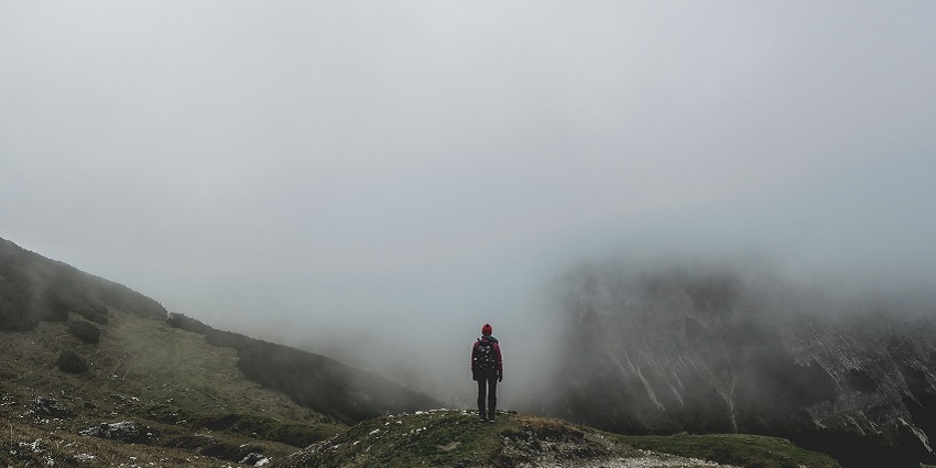 An image of a backpacker in the mountains on a trek similar to the Tholung Trek in Sikkim