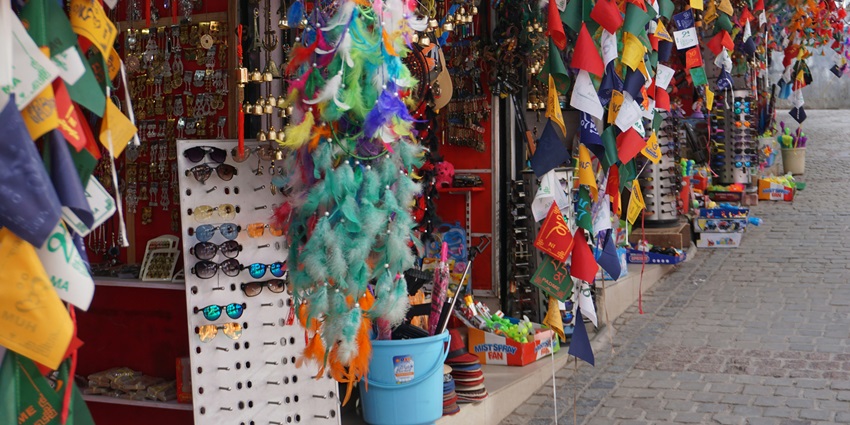 Tibetan souvenir shops near Namdroling Nyingmapa Monastery selling handmade crafts.