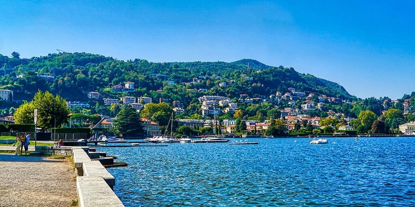 The deep blue waters of Lake Como and the stunning views of the surrounding hills.