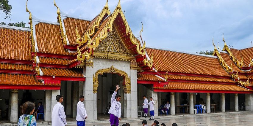 Respect local customs at Wat Pho Temple by dressing modestly and following cultural etiquette.