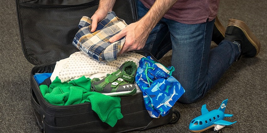A traveller’s bag packed with shoes, clothes, and accessories for a trip to Lamai Beach.