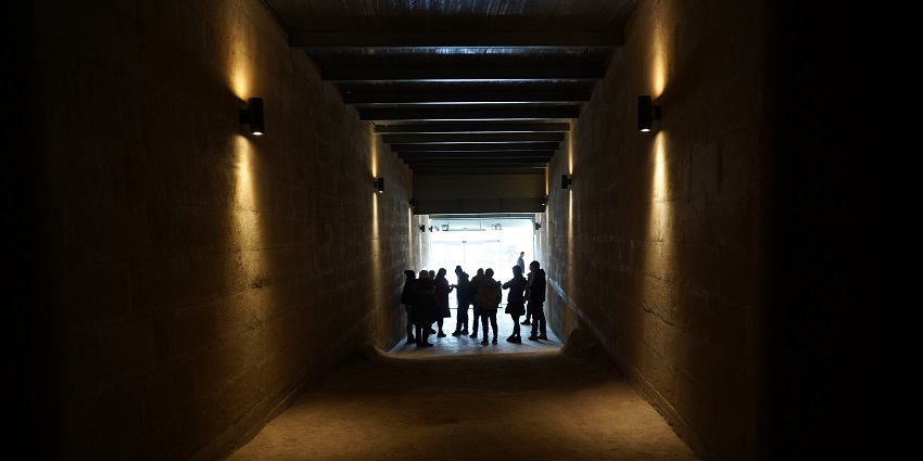 A picture of tourists exploring Kaymakli Underground City with a guide.