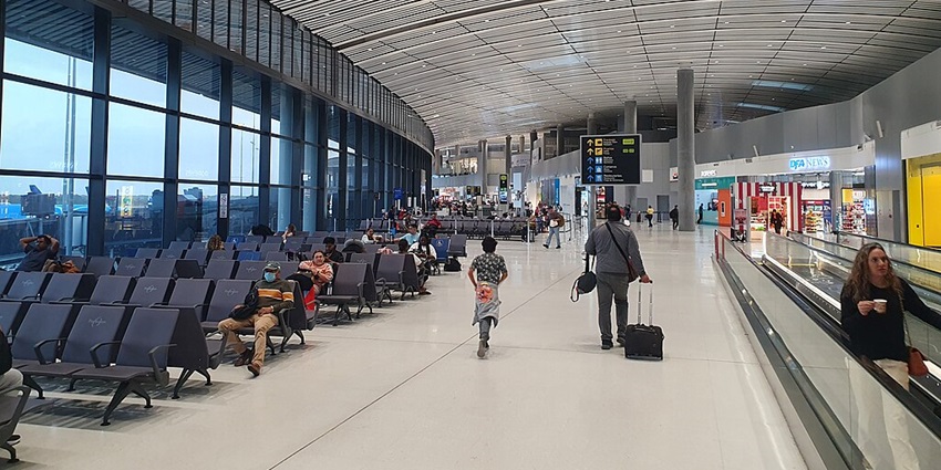 Terminal 2 of Tocumen International Airport with passengers seated on the left and a lift on the right