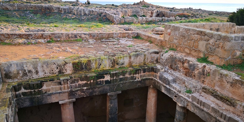 Ancient rock-cut Tombs of the Kings in Paphos, archaeological site, surrounded by ruins.