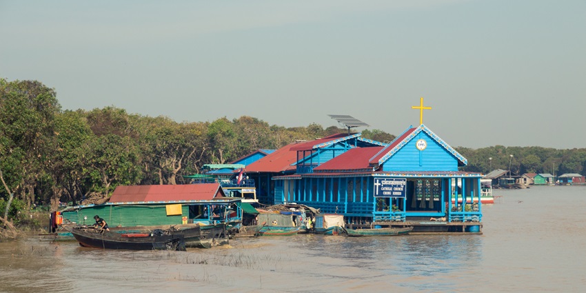 A scenic view of floating villages on Tonle Sap Lake, a unique tourist place in Cambodia for a honeymoon.