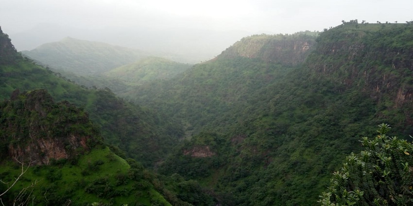An image of the Toranmal Hill Station with green valleys, waterfalls, and cool weather.