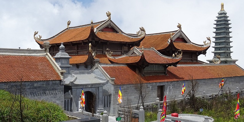 The stunning Fansipan Legend spiritual complex, enveloped in clouds and ancient structures.
