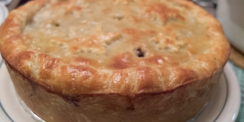 A savoury meat pie with a golden crust and spiced filling, the best food in Canada.
