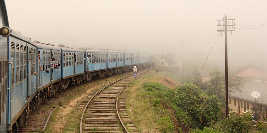 Scenic train ride from Kandy to Nuwara Eliya through misty hills and lush greenery.