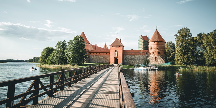 A view of Trakai Castle, a historic 14th-century fortress surrounded by a serene lake.