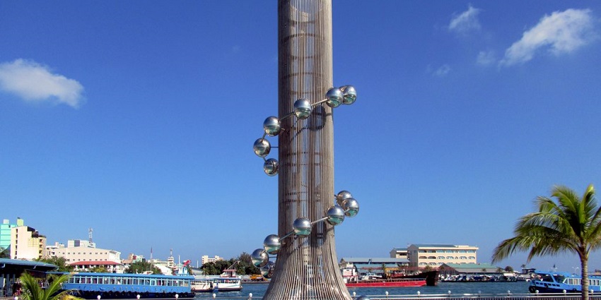 Memorial honoring tsunami victims, featuring symbolic metal spheres by the sea